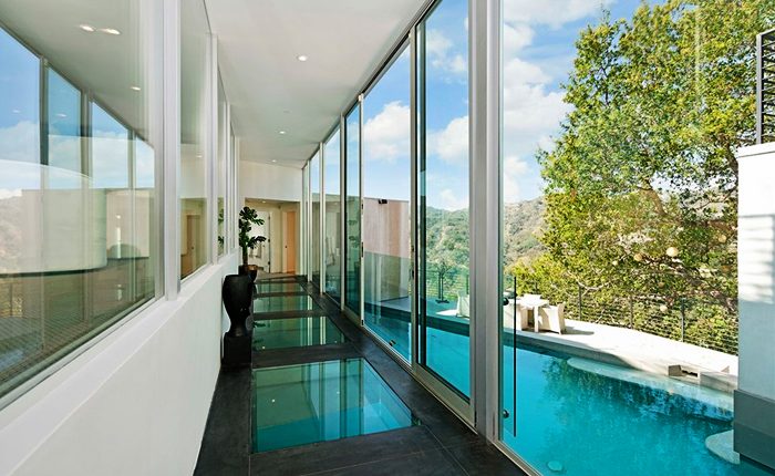 Oak Pass Contemporary Modern Home with enclosed glass hallway.
